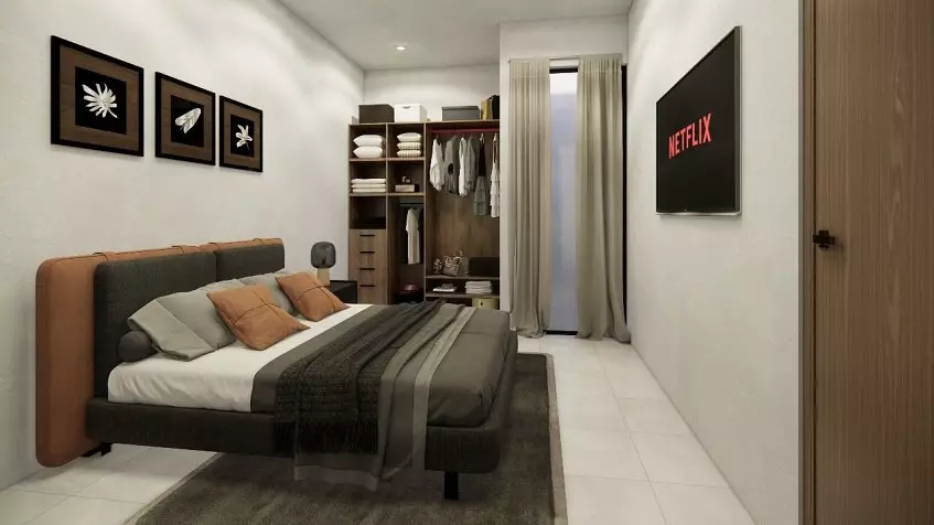 Bedroom with a bed facing the TV screen, built-in closet in South 307 Condos