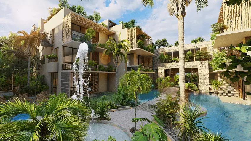 Jardín de alberca entre edificios residenciales, fuente entre áreas verdes en Le Releve Cenote Tulum