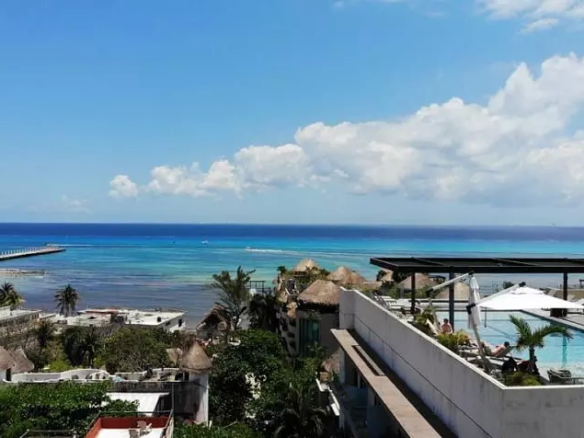 View of a rooftop with a pool and ocean at Isabella Condos