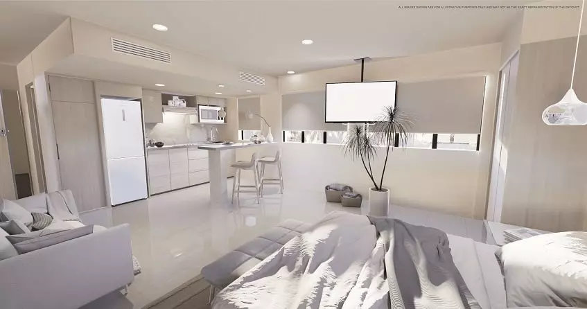 Interior de estudio blanco con cocina, cama y sofá en Fifty Blanc Playa del Carmen