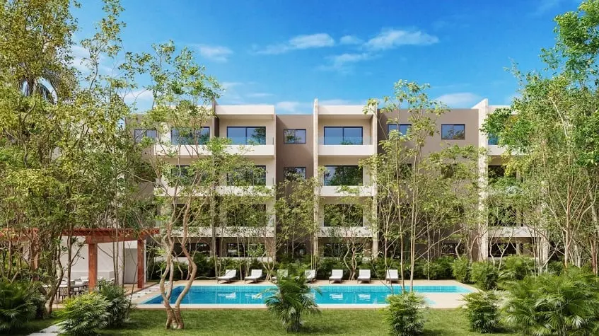 Fachada de edificio residencial con jardín de piscina en Selvanova Playa del Carmen