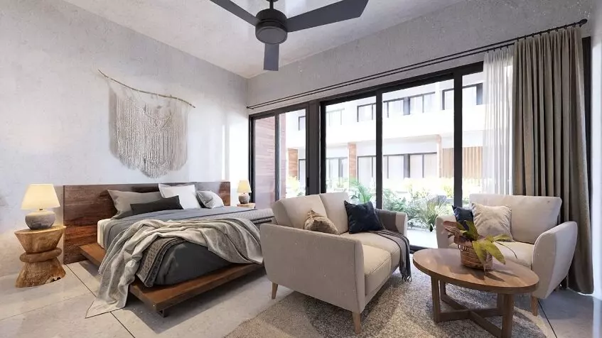Interior de apartamento con cama, sofás y mesa de café en Kateen Tulum