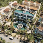 Vista aérea de un conjunto residencial con piscinas, planta baja y azotea, así como piscinas de inmersión en Satori Tulum