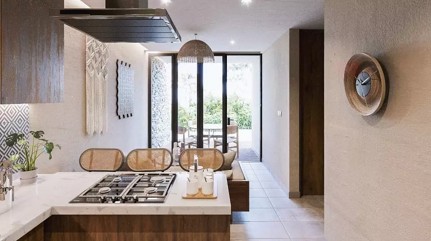 Desayunador al final de la bancada de la cocina, sala y terraza en Ocean Condos Tulum