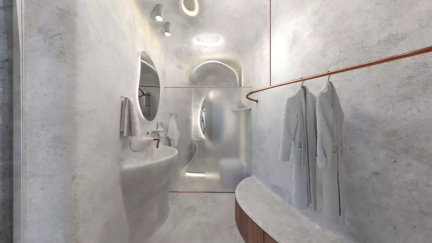 Baño blanco casi transparente con regadera y bata colgada en Azulik Residences Tulum