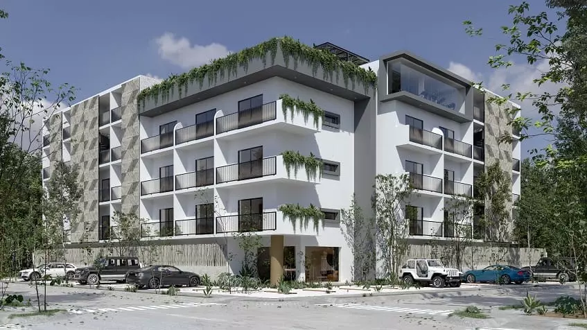 Edificio residencial blanco con plantas verdes merodeando por Lik Xelba Tulum