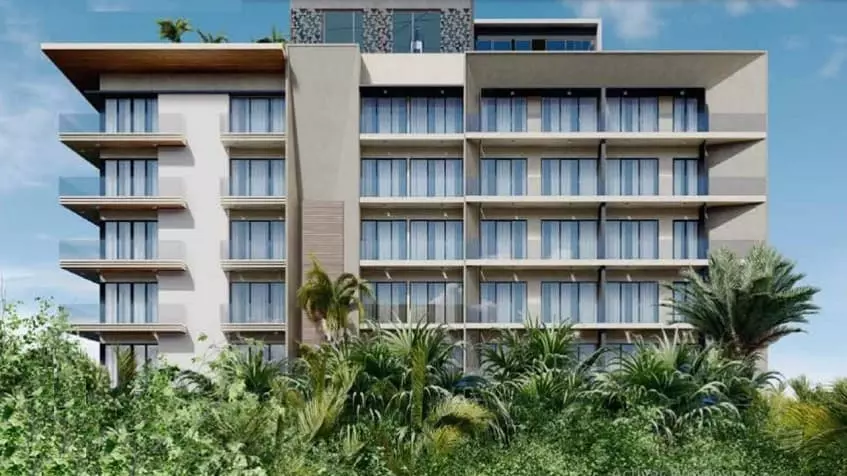Facade of residential building, palm trees in front in Quartier 75 Playa del Carmen