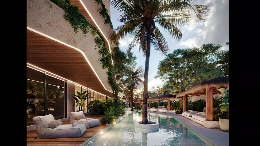 Terraza de la piscina con algunas palmeras y sala de estar en Brahma Tulum