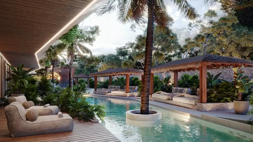 Terraza de la piscina con algunas palmeras y sala de estar en Brahma Tulum