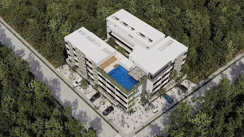 Vista aérea de un edificio residencial blanco en la esquina de la calle, piscina, jungla en Lik Xelba Tulum