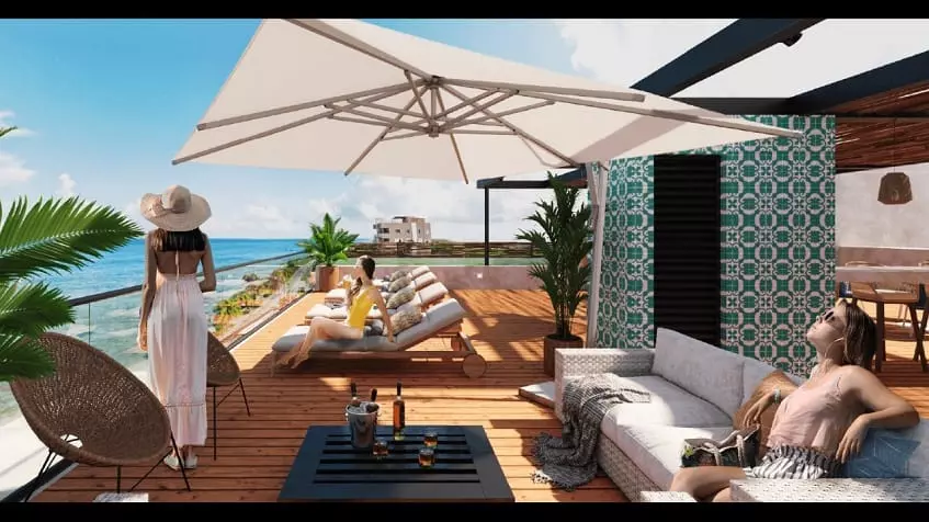 Una terraza con 3 mujeres y vista al mar en Nala Cozumel
