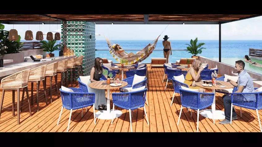 Una terraza, un bar y un restaurante con vista al mar en Nala Cozumel