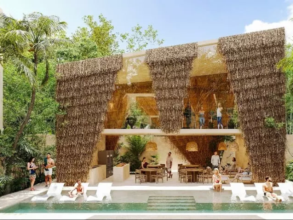 Façade d'un bar, d'une piscine et de personnes buvant des cocktails à Noi Tulum