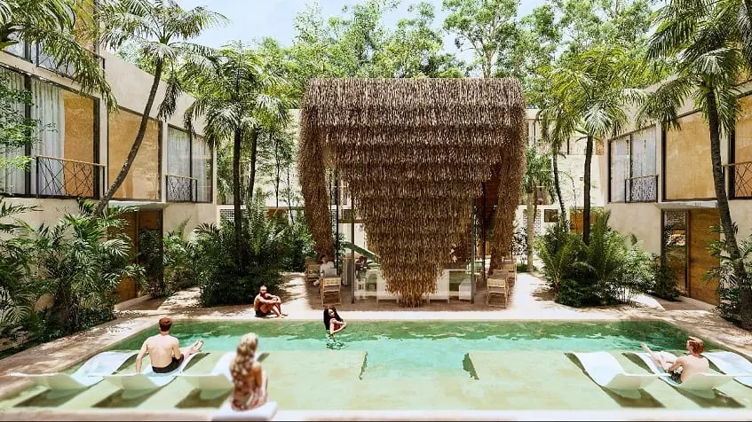 Una piscina, camastros y adultos disfrutando en Noi Tulum