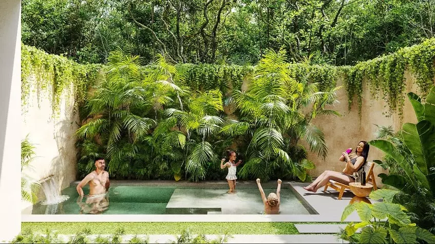 Una familia en piscina y jardín en Noi Tulum