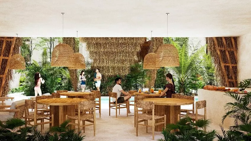 Un restaurante, mesas, sillas y personas platicando en Noi Tulum
