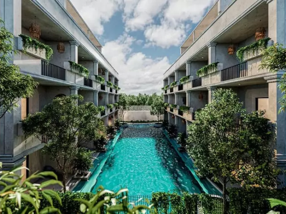 Dos fachadas de edificios y una alberca en el medio en Core Tulum