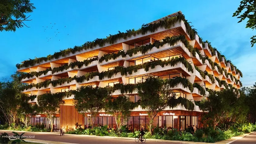 Fachada principal de edificio de departamento con plantas decorativas en Nequen del Mar Tulum