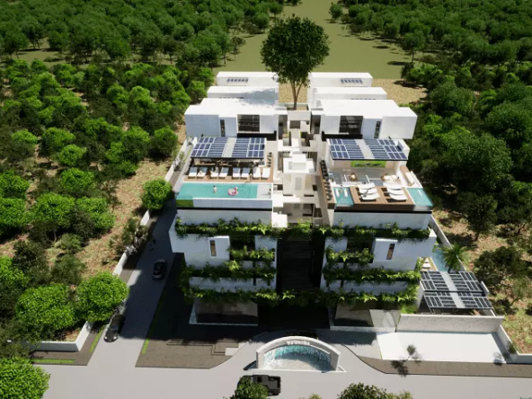 Vista aérea de edificio nuevo, paneles solares, varios arboles en Arvore Cancun