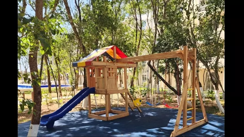 Children's playground with swings and backyard pool at La Selva Residences
