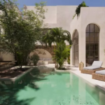 A pool and lounge chairs at Orquideas Tulum
