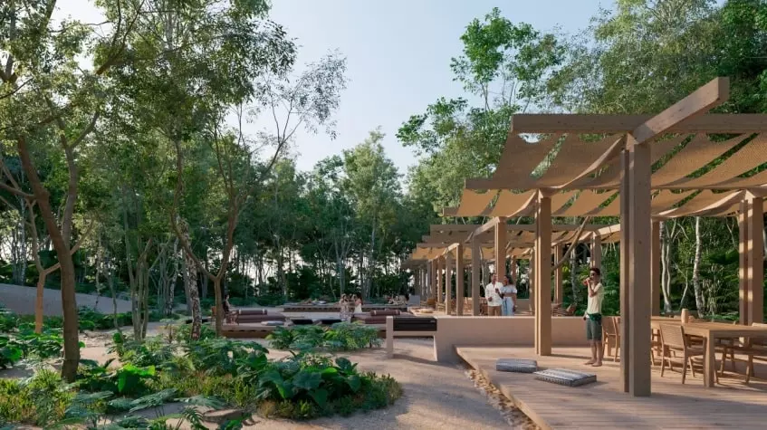 Un area comun con jardines y pergolas en Lunara Akumal