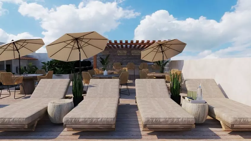 Un asoleadero con mesas y sillas en Monarca 28 Beach Town