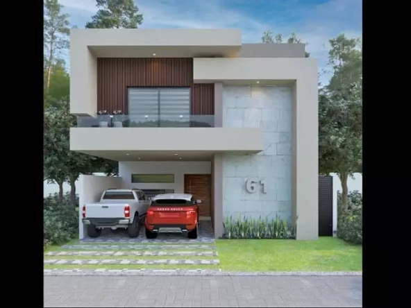 Una fachada de una casa de 2 niveles con 2 carros estacionados en Valenia Residencial Playa del Carmen