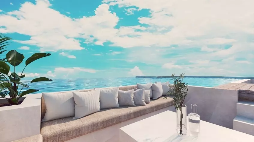 Una terraza con un sofa y vista al mar en Monarca 28 Beach Town