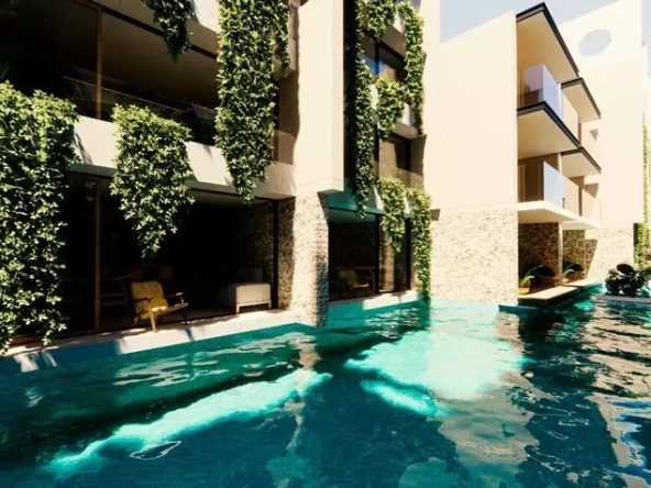 Una alberca swim up en Kuxtal Luxury Residences Tulum