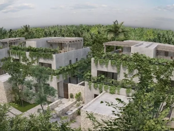 Vista aerea de varias casas y jardin alrededor en Janus Tulum