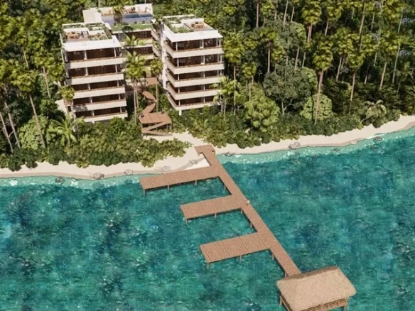 Aerial view of a pier and two oceanfront buildings in Mayacatl