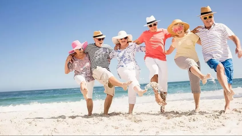 Un grupo de estadounidenses retirados bailando sobre la playa