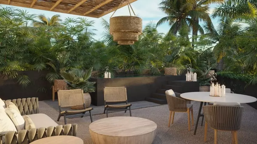 Una terraza con sillas y plantas en Macadam Jungle Tulum