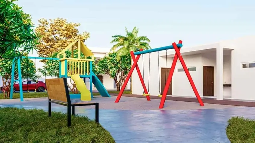 Un area de juegos para niños y baños al fondo en Villas Bonanza
