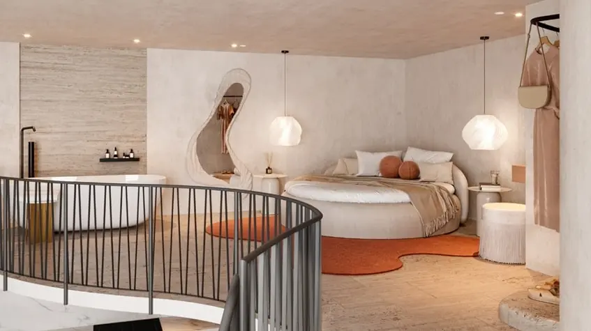 Una cama en forma minimalista y una tina de baño en The Curve Tulum