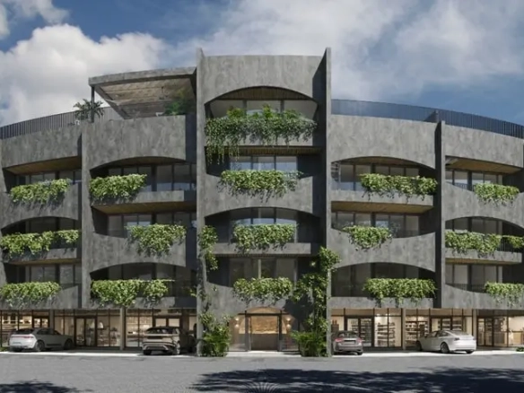 Fachada de un edificio de departamentos con locales comerciales en Ardeh Tulum