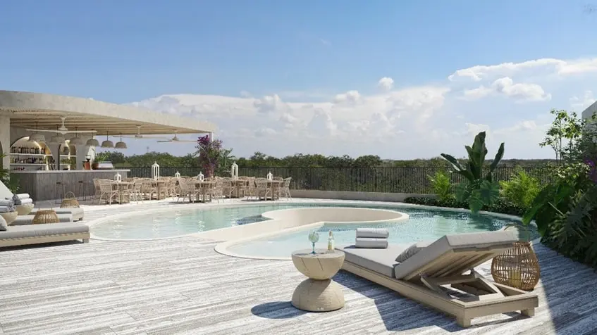A pool with lounge chairs and bar area at Ardeh Tulum