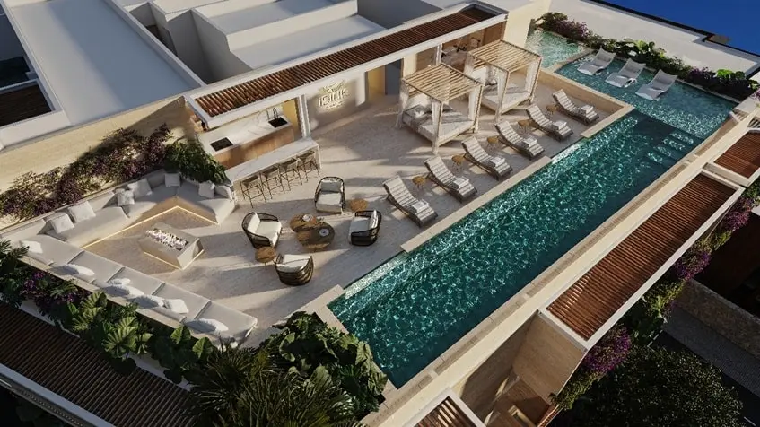 Vista aera de una terraza con alberca y camastros en Idilik Residences Playa del Carmen
