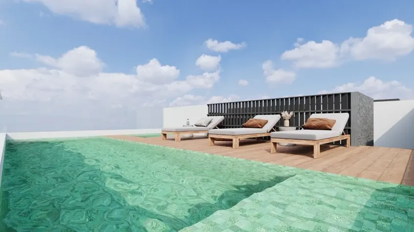 Un area de alberca con camastros en Black Savage Playa del Carmen