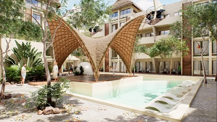 Una alberca y una palapa de yoga en Naia Uhm Tulum