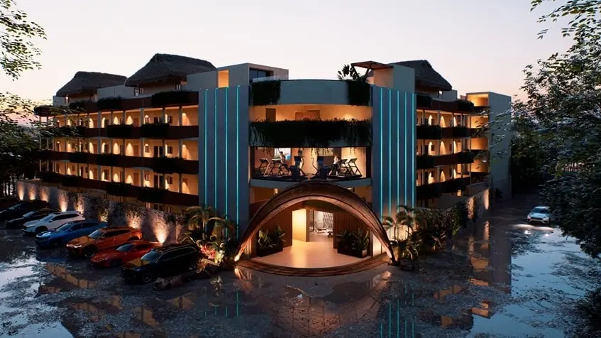 Fachada edificio atardecer con estacionamiento de Naia Uhm Tulum