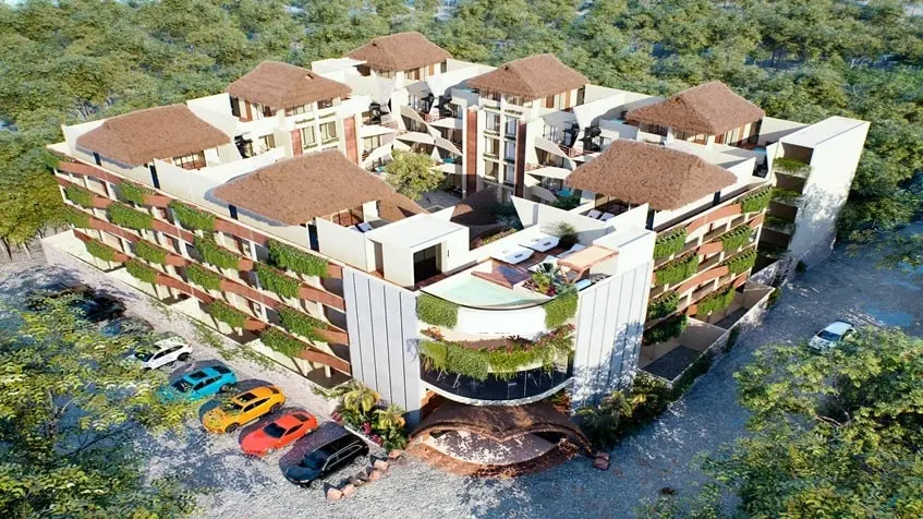 Vista aerea de un edificio de departamentos y un estacionamiento en Naia Uhm Tulum