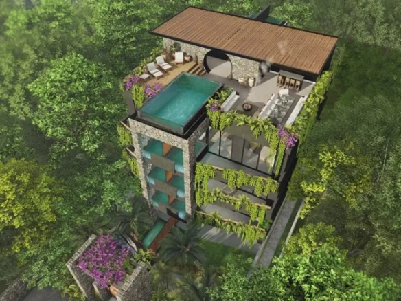 Vista aerea de una torre de departamentos y una alberca en la terraza en Malek Tulum