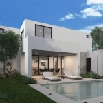 An indoor pool with gardens and lounge chairs in Adara Mérida
