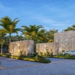 A main entrance with a security booth in El Amate Playa del Carmen