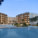 An exterior facade of an apartment building with a pool in Distrito Zen Puerto Cancun