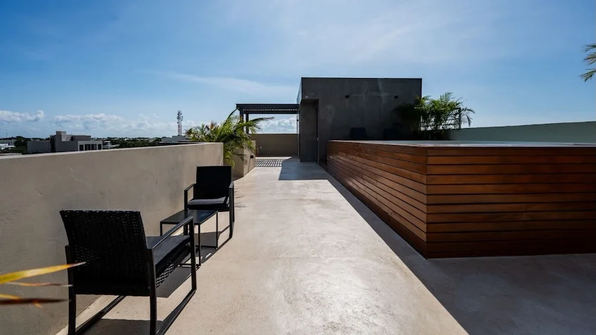 A terrace with a pool and rooftop at Amanecer Condos Playa del Carmen