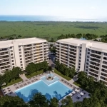 Aerial view of a real estate development with a pool in the middle at Vanguardia Residences Puerto Morelos