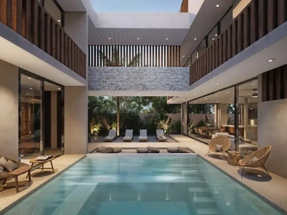 Interior con alberca camastros en Atia Essence Tulum